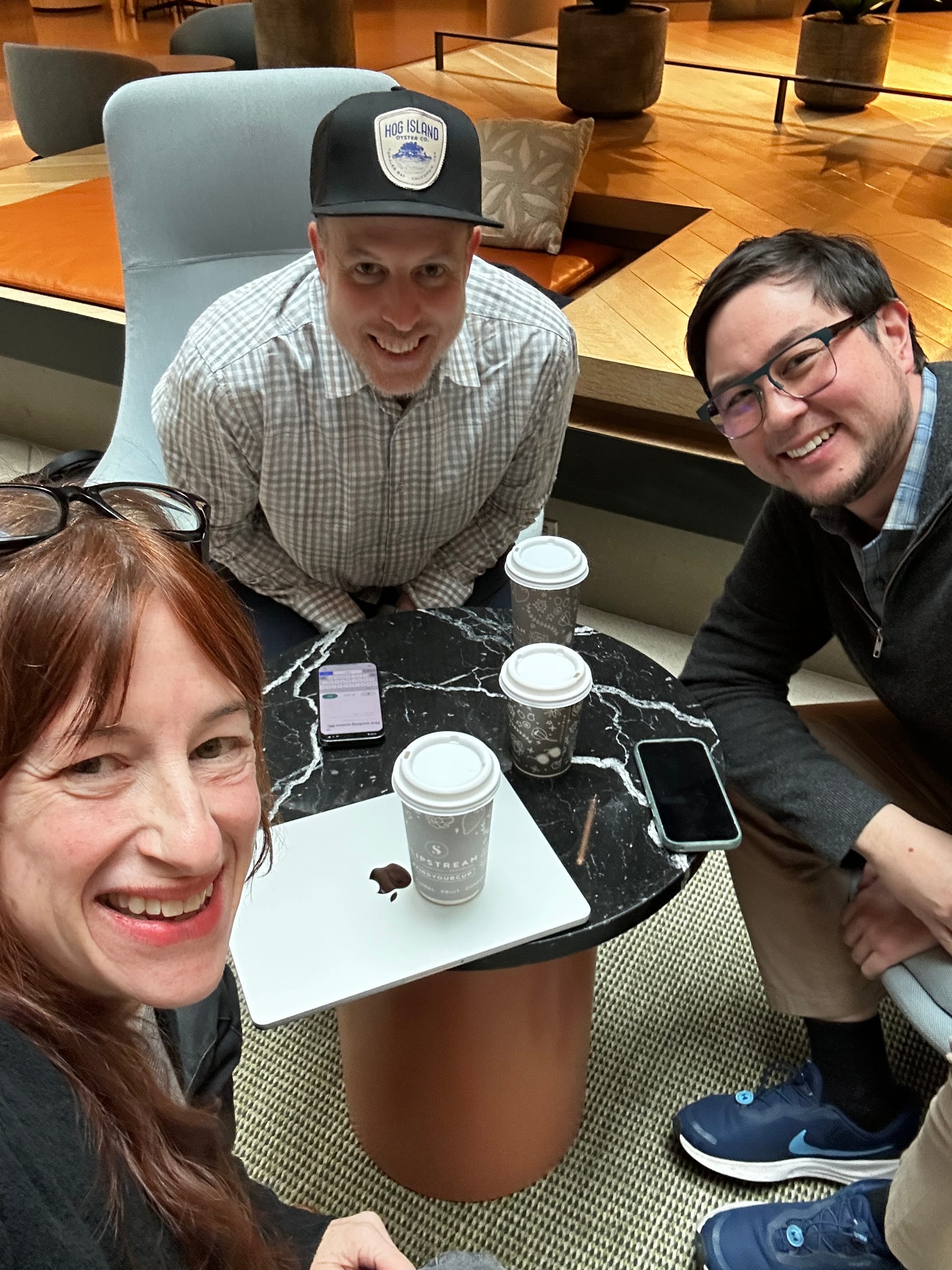 group selfie of three smiling people 