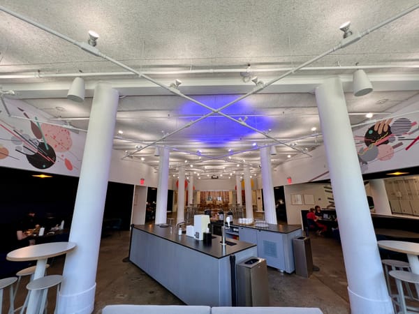 Wide angle photo of the Betworks main hall during the day, with a bar in the foreground